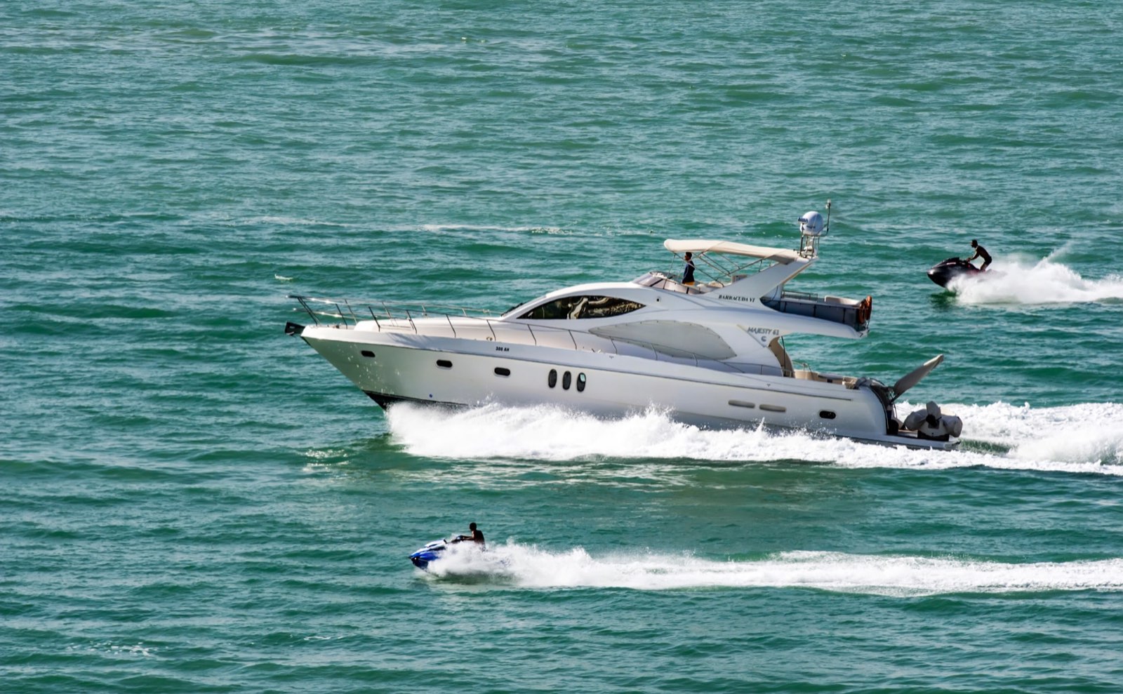 Yacht and jet ski on the water