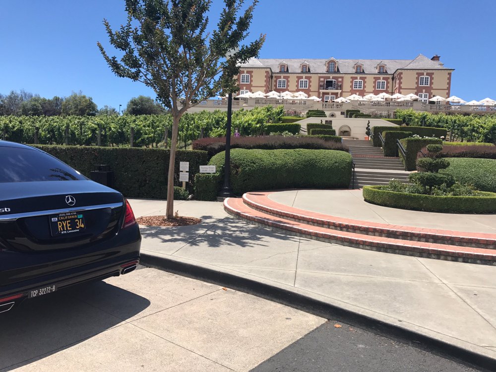 Black sedan parked at a hilltop winery