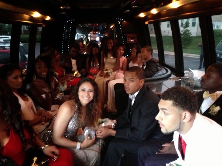 Prom group celebrating inside a party bus