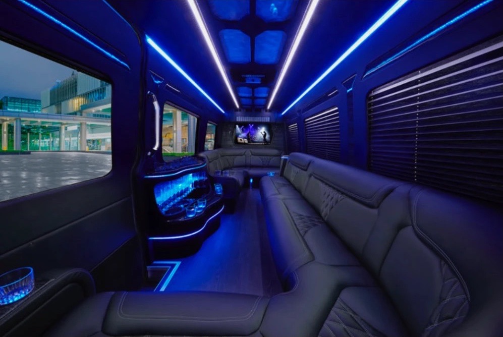 Wraparound leather seating and LED ceiling inside a VIP Sprinter