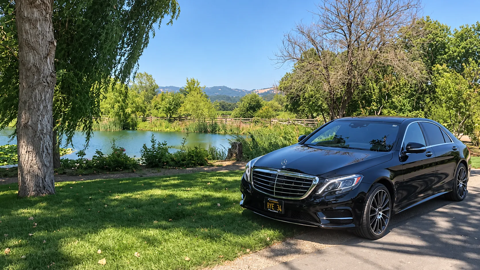 Black Mercedes-Benz S-Class by a lake in wine country